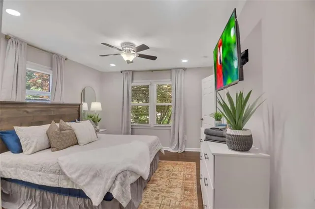 a bedroom with a bed a potted plant and a window