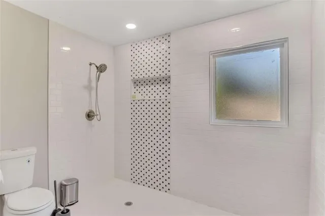 a bathroom with a shower toilet and sink