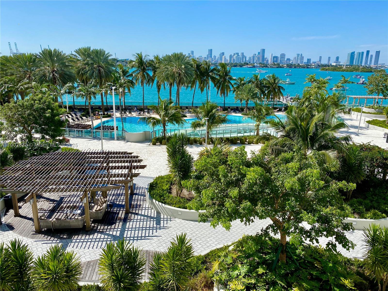 1500 Bay Road, Unit 846S Miami Beach, FL 33139 - Photo 34 of 40 a view of a lake with a bench and a yard