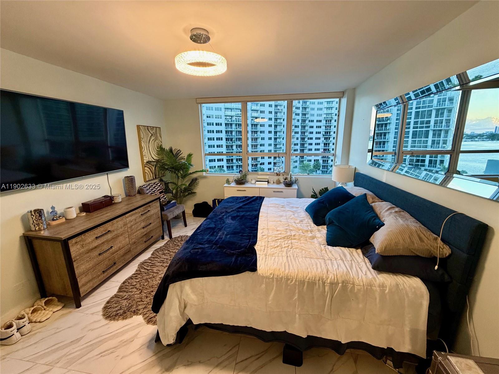 1500 Bay Road, Unit 846S Miami Beach, FL 33139 - Photo 10 of 40 a large bedroom with a bed and large windows