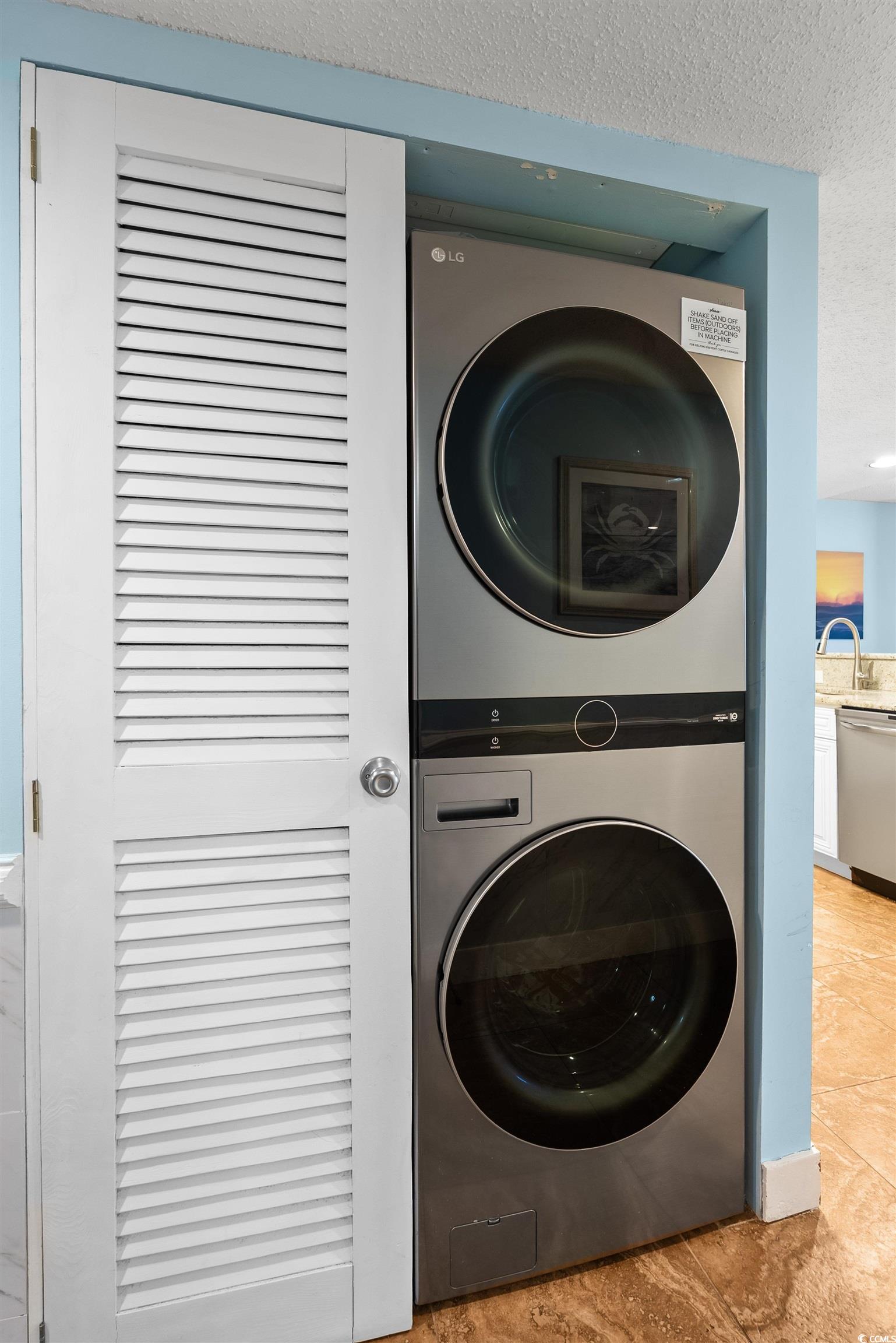 205 74th Avenue North, Unit 1908 Myrtle Beach, SC 29572 - Photo 12 of 39 Laundry area featuring a textured ceiling and stacked washer and clothes dryer