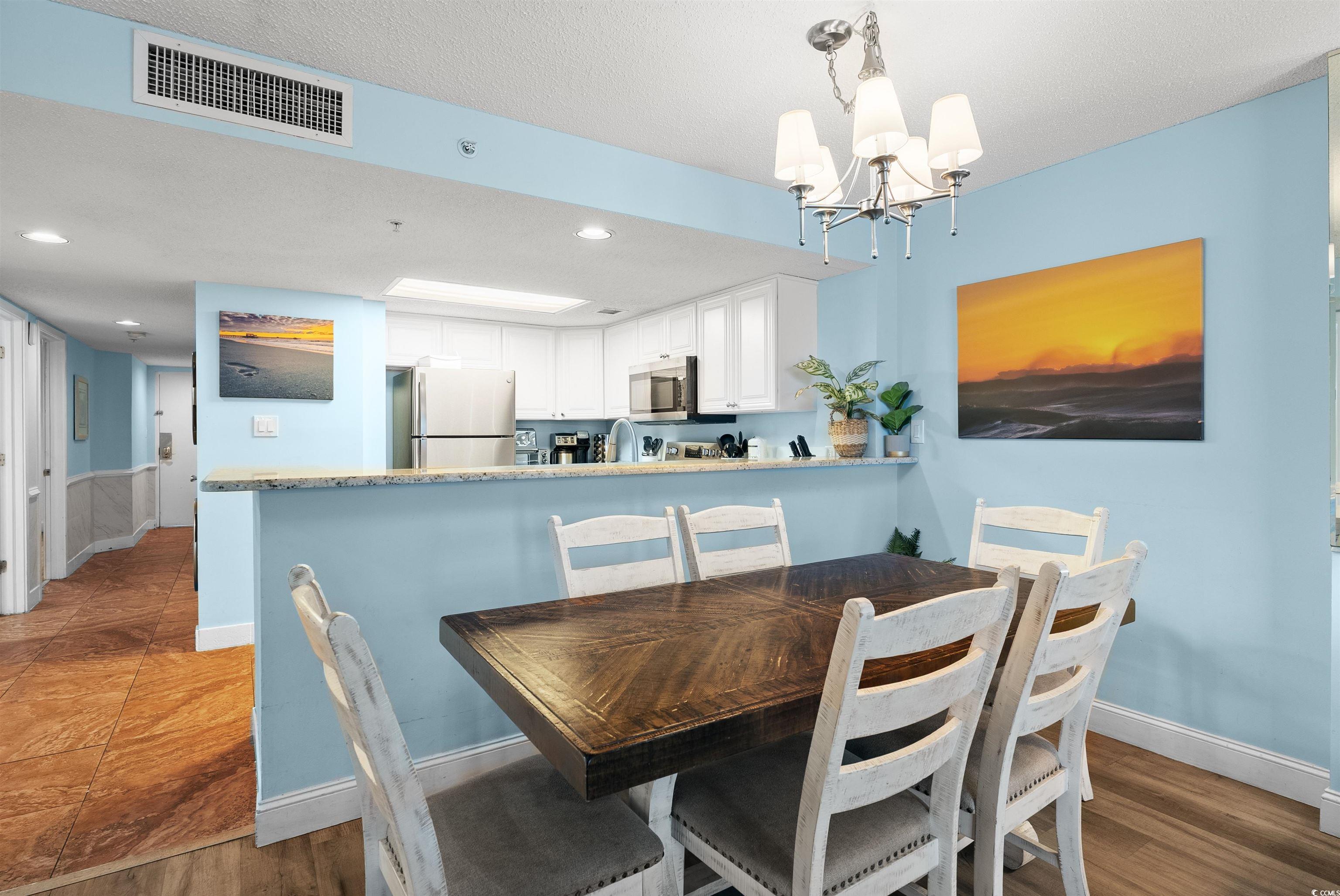 205 74th Avenue North, Unit 1908 Myrtle Beach, SC 29572 - Photo 15 of 39 Dining area with recessed lighting, a chandelier, and dark wood finished floors
