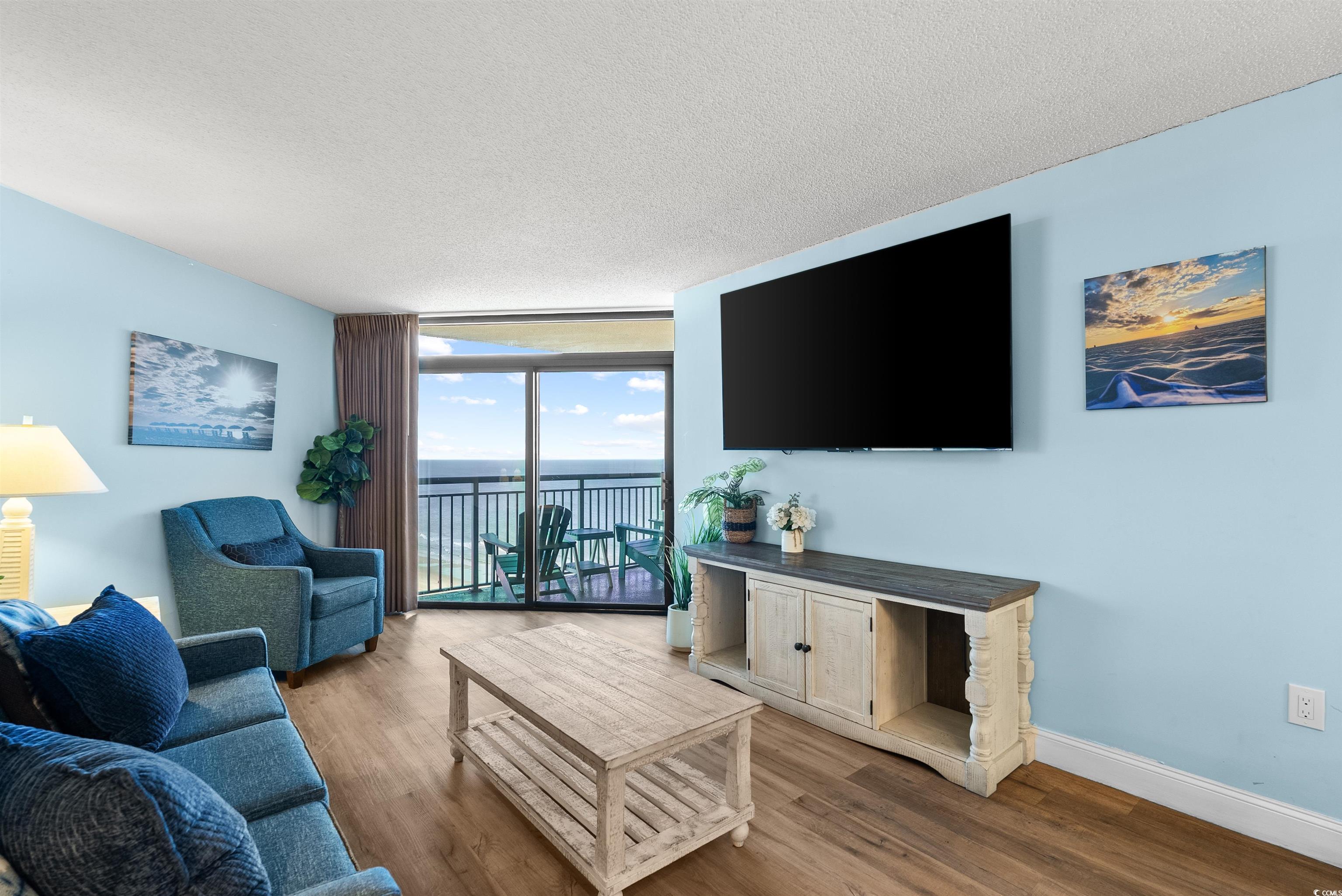 205 74th Avenue North, Unit 1908 Myrtle Beach, SC 29572 - Photo 16 of 39 Living area with expansive windows, a textured ceiling, and wood finished floors