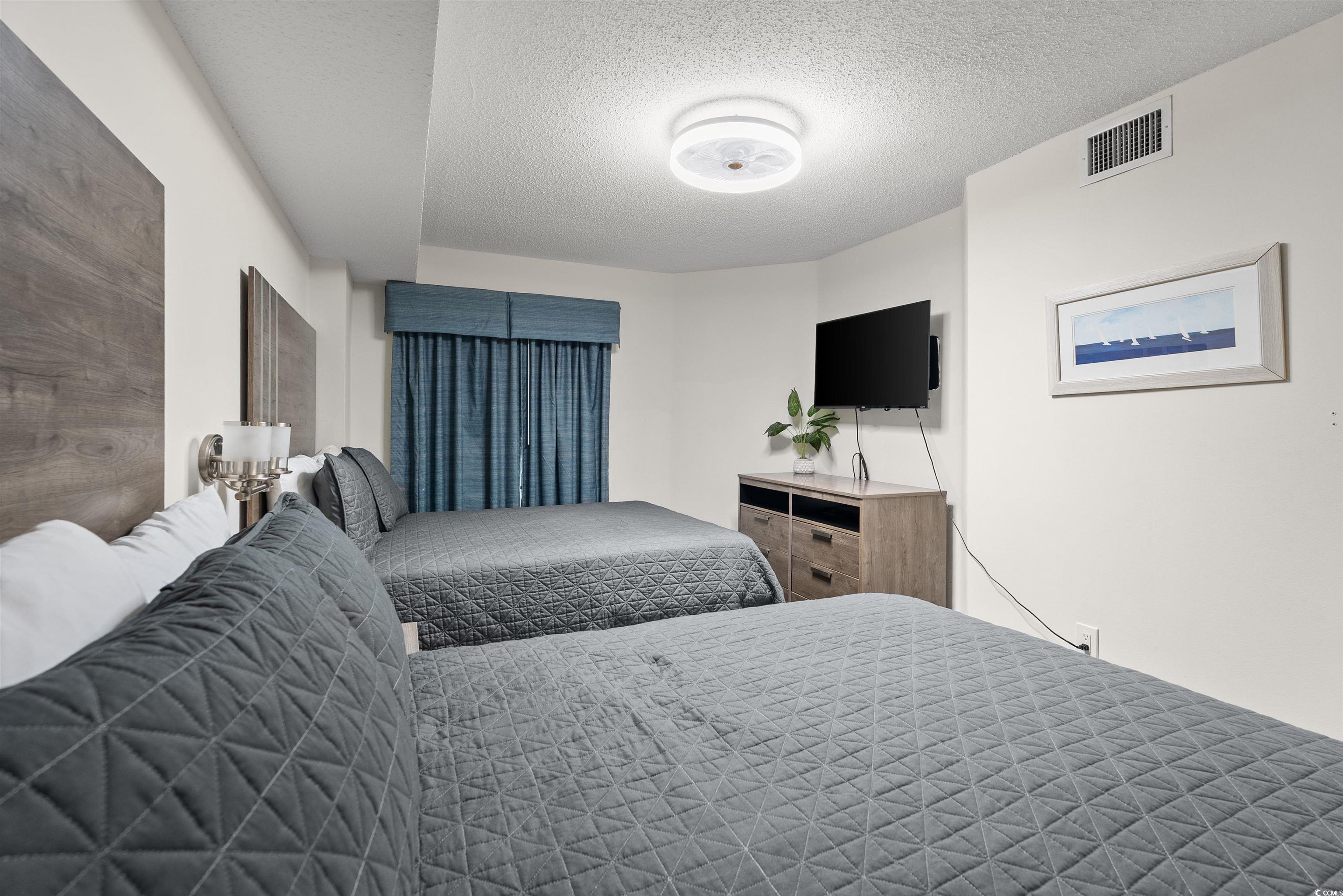 205 74th Avenue North, Unit 1908 Myrtle Beach, SC 29572 - Photo 23 of 39 Bedroom with a textured ceiling