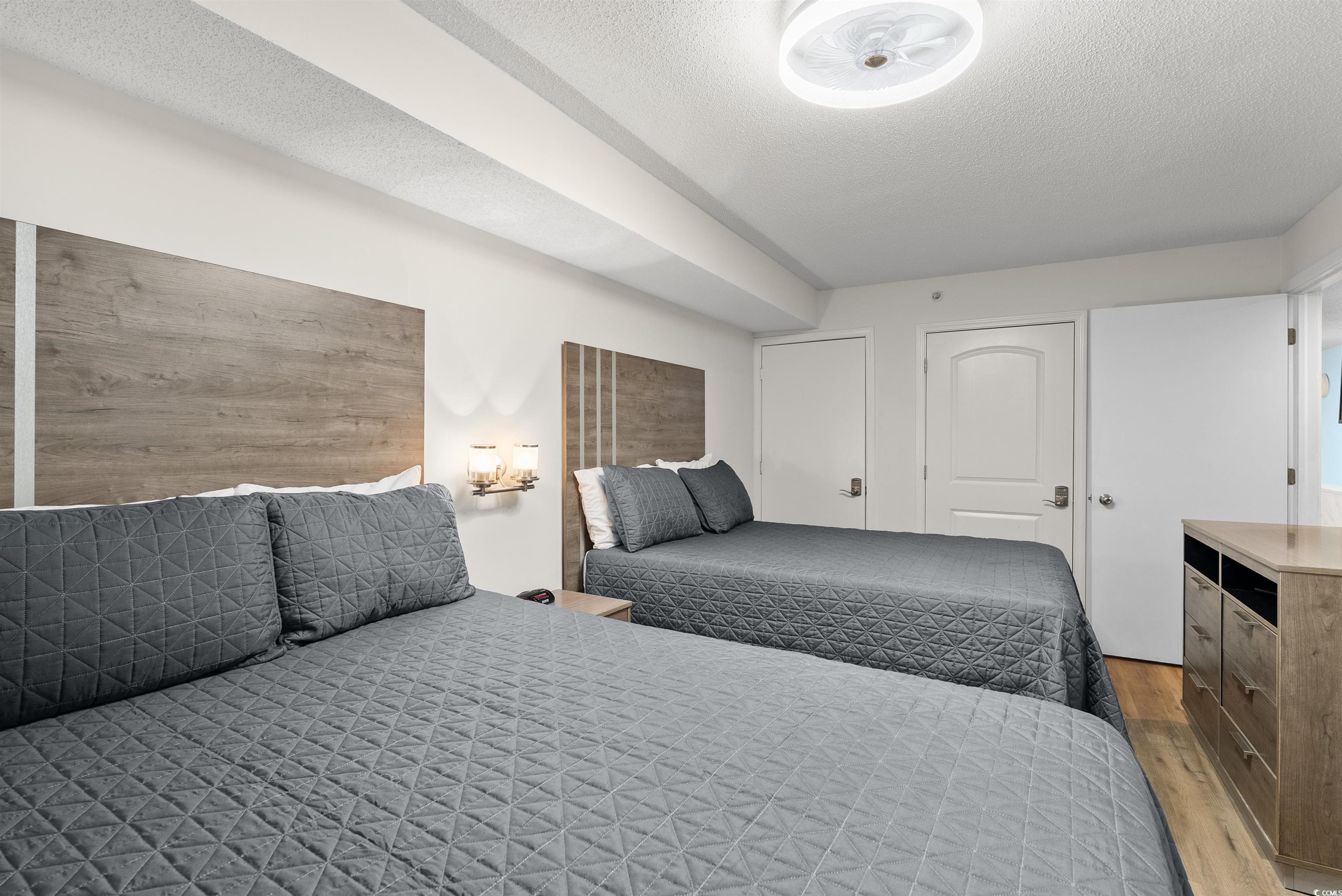 205 74th Avenue North, Unit 1908 Myrtle Beach, SC 29572 - Photo 31 of 39 Bedroom with a textured ceiling and wood finished floors