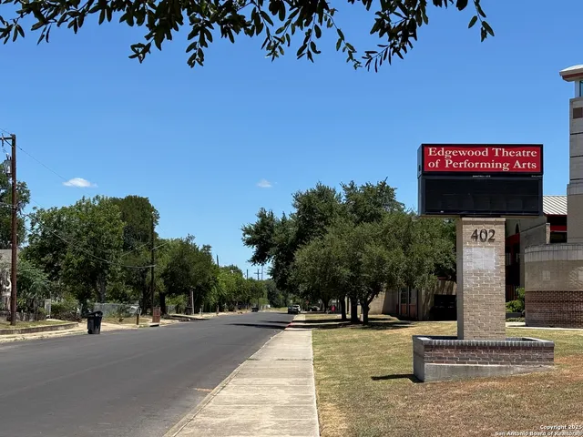 a view of a field with trees in the background