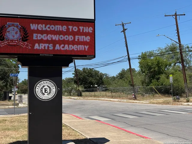 a view of a field with trees in the background