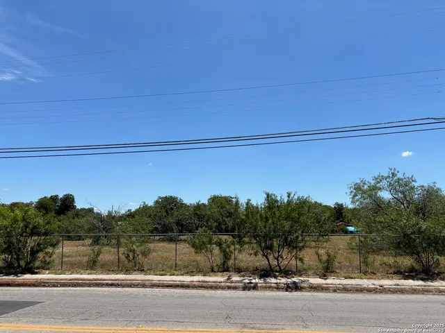 a view of a field with trees in the background