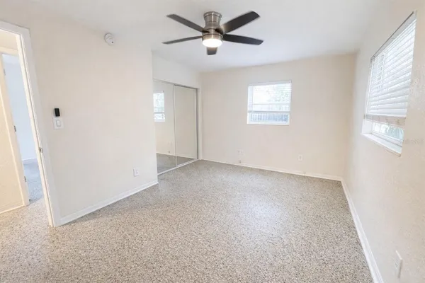 a view of a livingroom with a ceiling fan and window