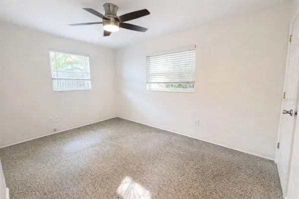 a view of a livingroom with a ceiling fan and window