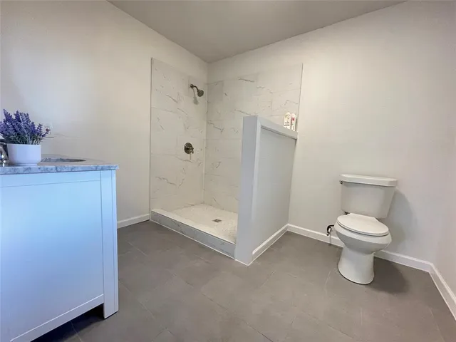 a bathroom with a toilet a sink and shower