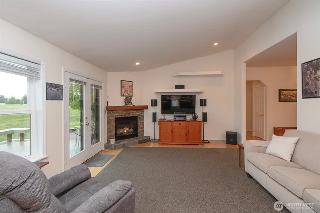 a living room with furniture a fireplace and a flat screen tv