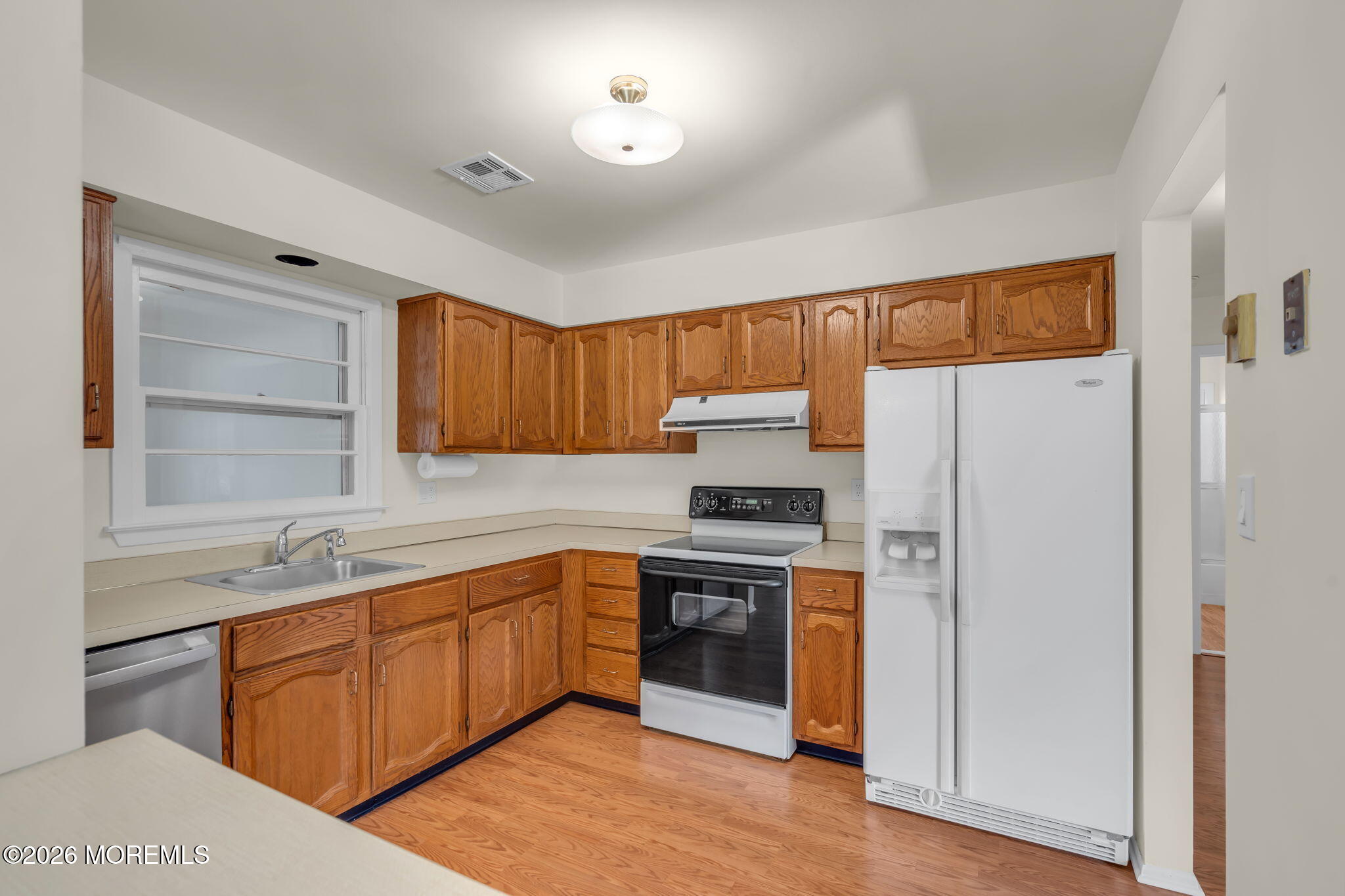 14 Thames Place Brick, NJ 08723 - Photo 14 of 37 a kitchen with a sink a refrigerator and cabinets