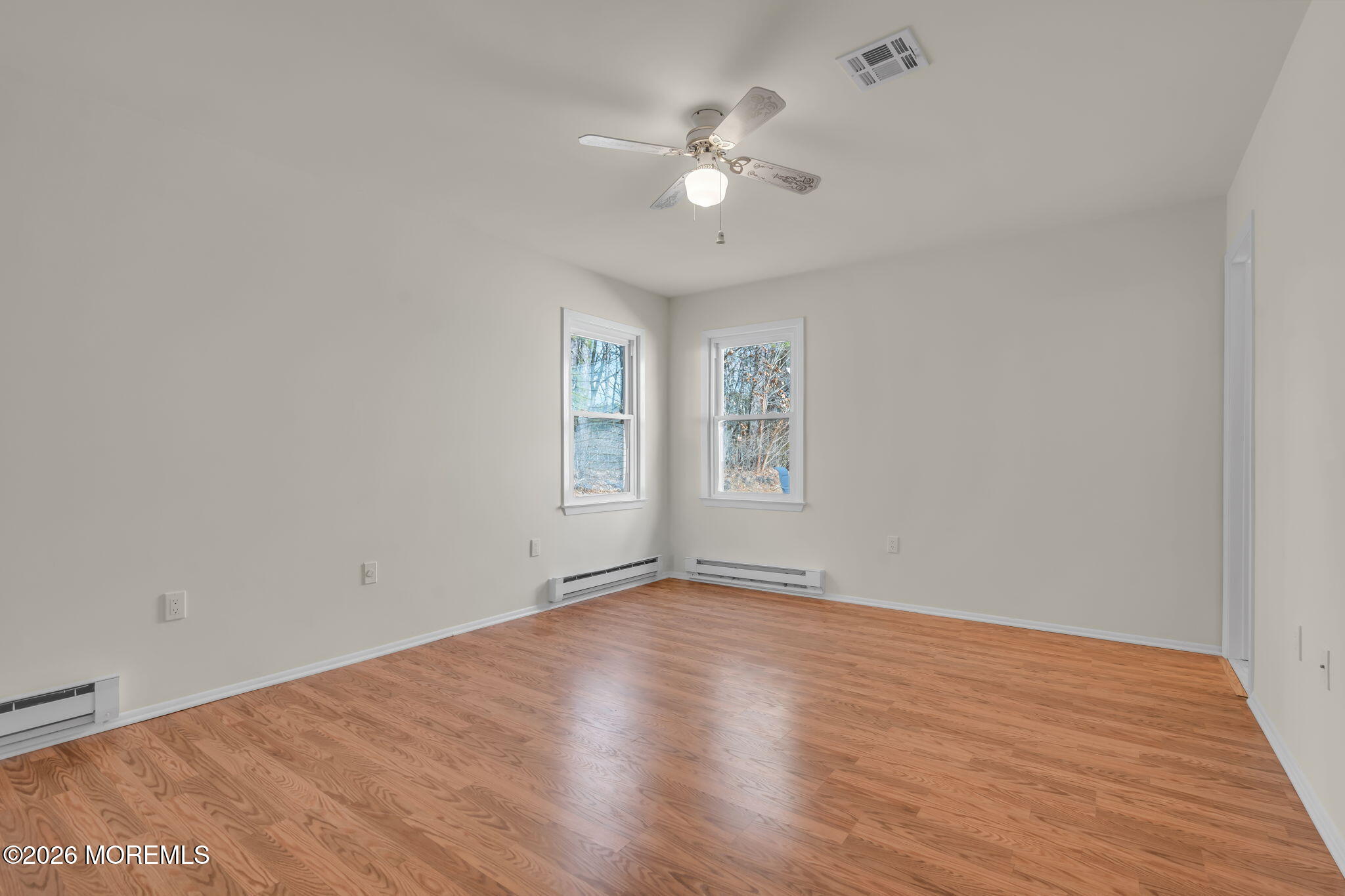 14 Thames Place Brick, NJ 08723 - Photo 20 of 37 a view of an empty room with wooden floor and a window