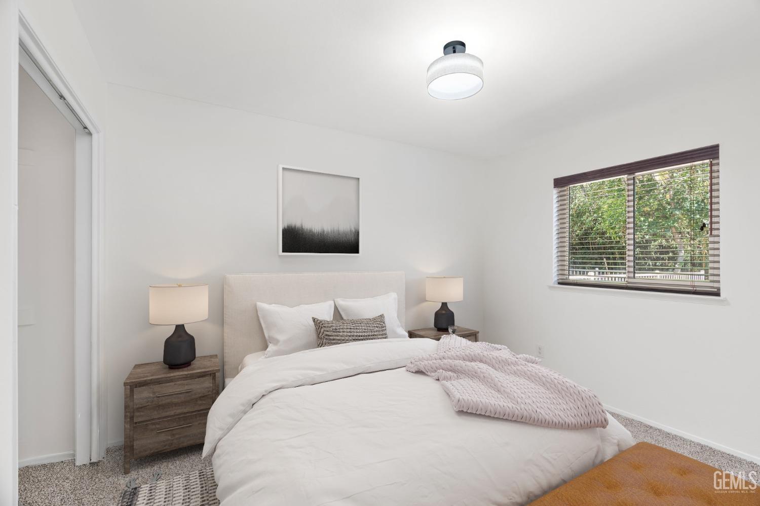 Undisclosed Address Bakersfield, CA 93309 - Photo 15 of 32 a bedroom with a bed and a night stand