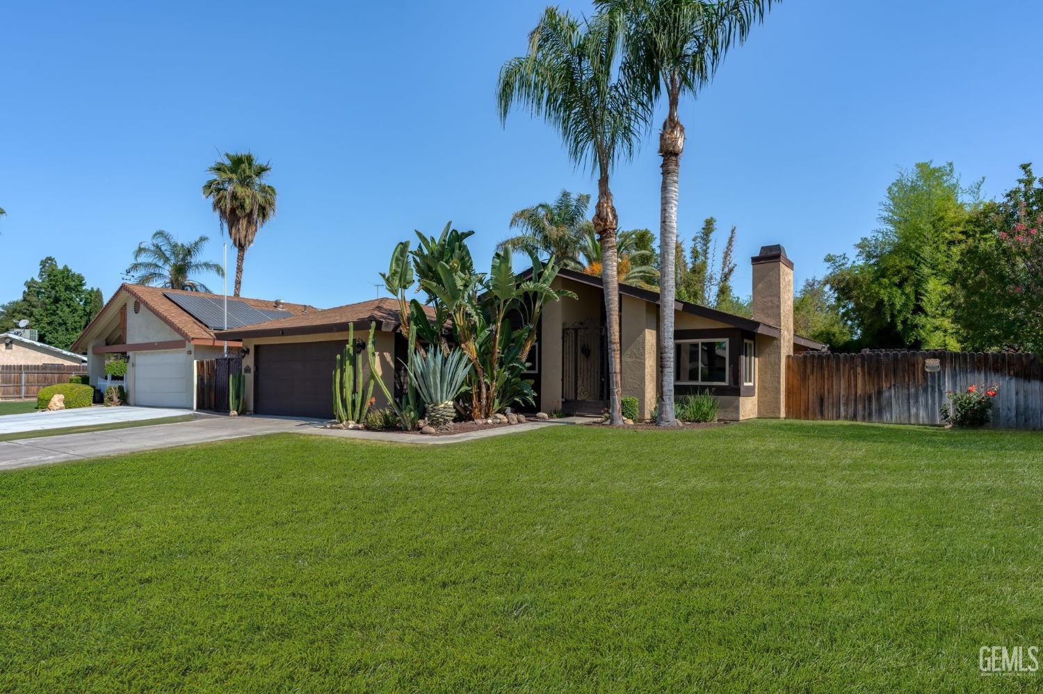 Undisclosed Address Bakersfield, CA 93309 - Photo 2 of 32 a front view of a house with garden