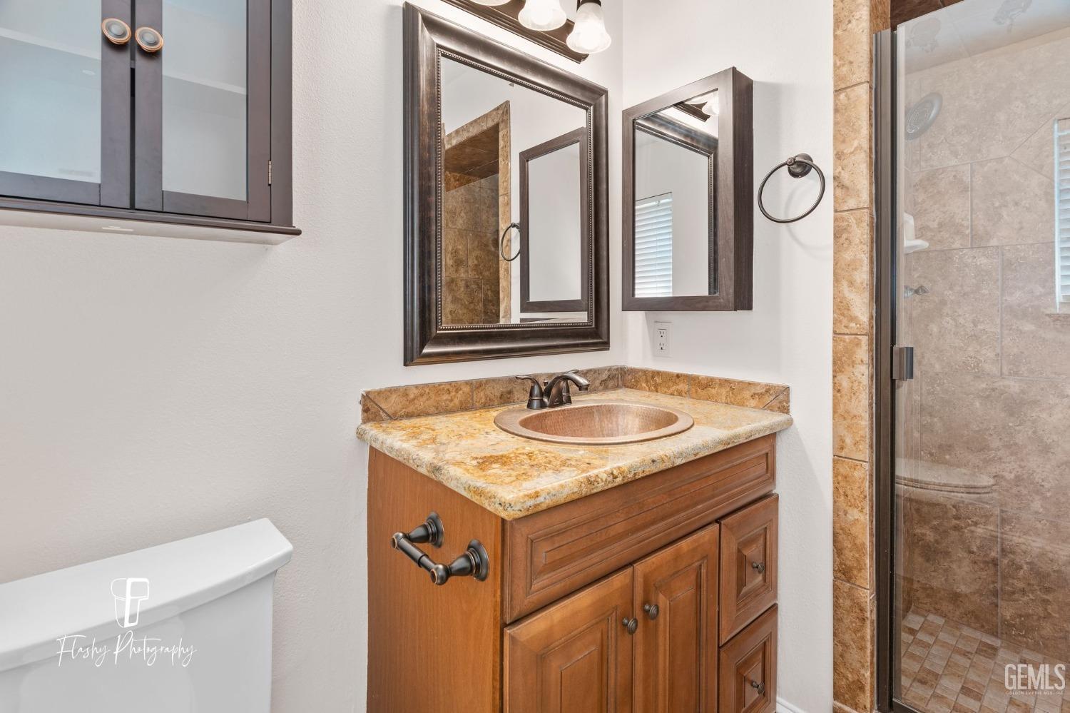 Undisclosed Address Bakersfield, CA 93309 - Photo 24 of 32 a bathroom with a sink and a toilet