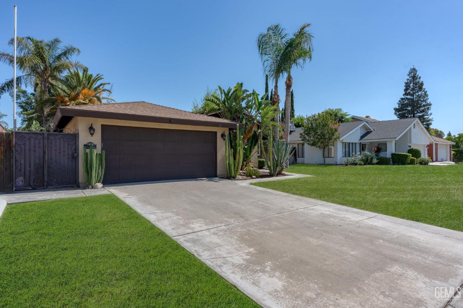 Undisclosed Address Bakersfield, CA 93309 - Photo 3 of 32 a front view of house with yard and green space