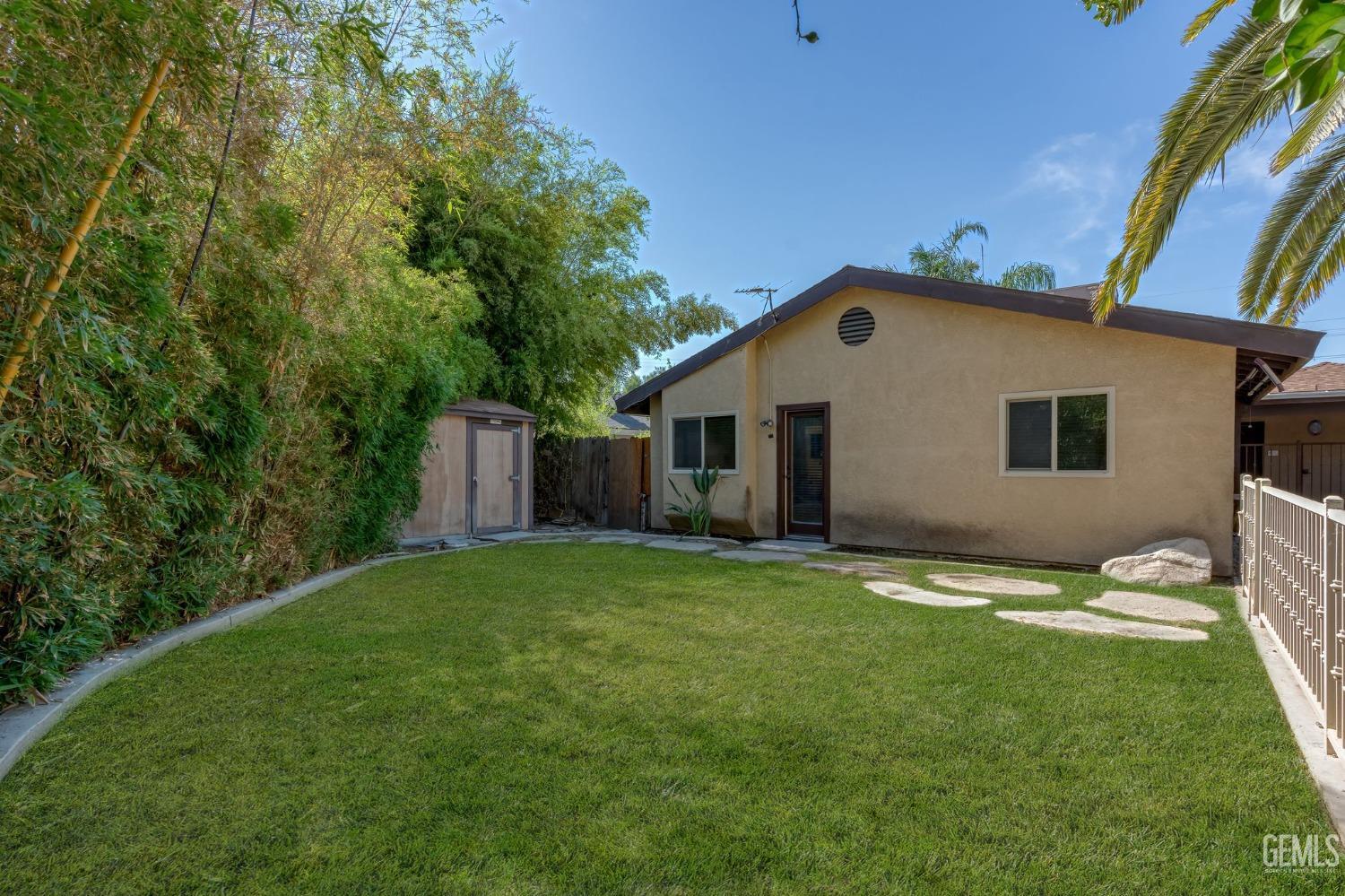 Undisclosed Address Bakersfield, CA 93309 - Photo 32 of 32 a view of a backyard with plants and large tree