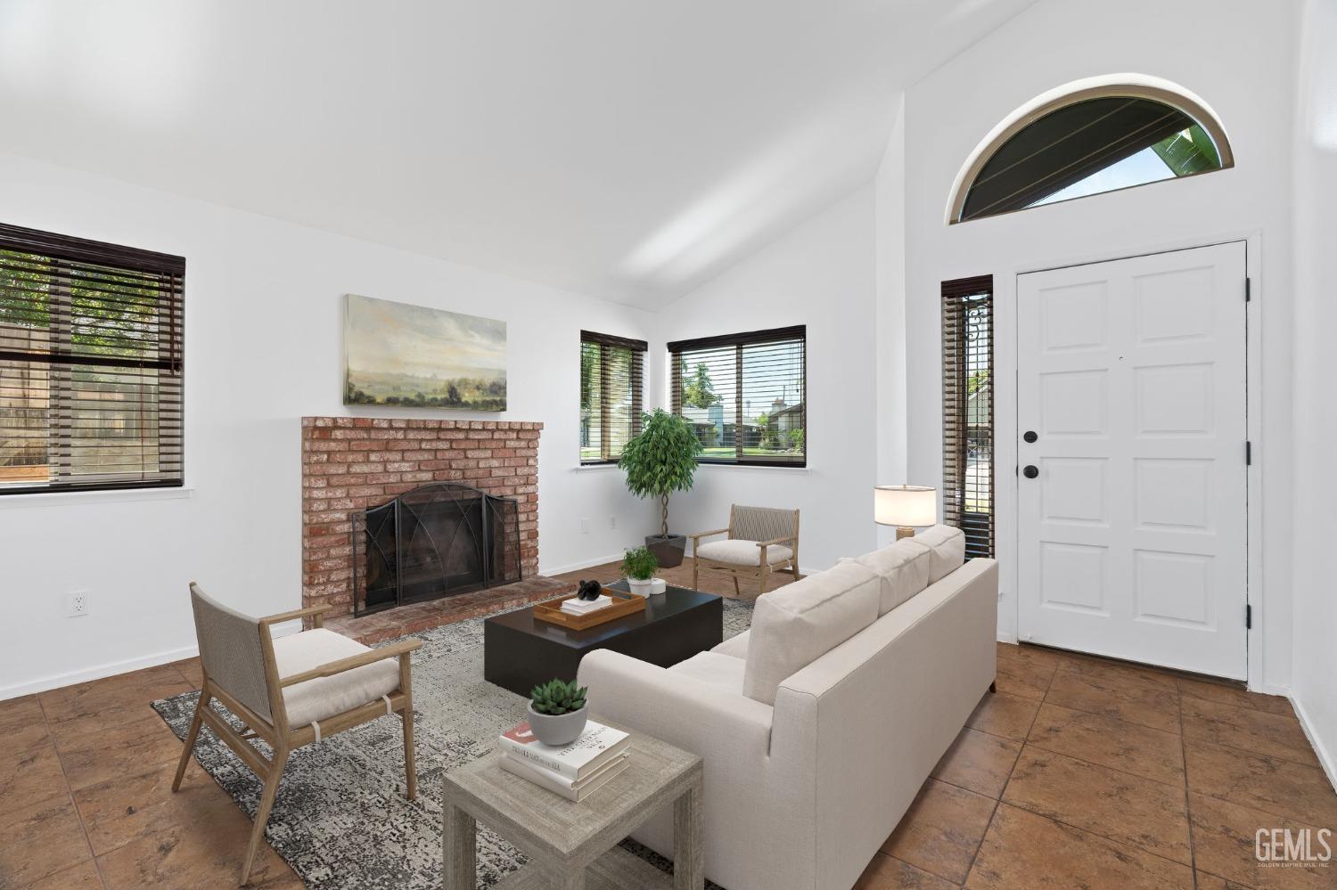 Undisclosed Address Bakersfield, CA 93309 - Photo 7 of 32 a living room with furniture a fireplace and a potted plant