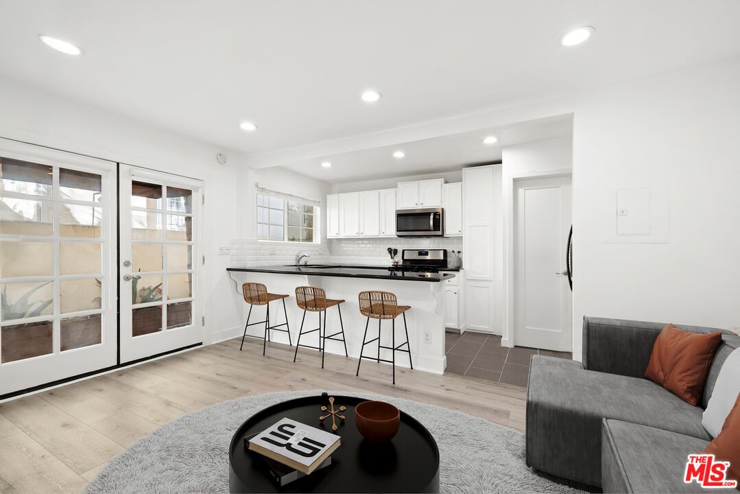 927 Euclid Street, Unit B Santa Monica, CA 90403 - Photo 3 of 8 a living room with furniture and a view of kitchen appliances