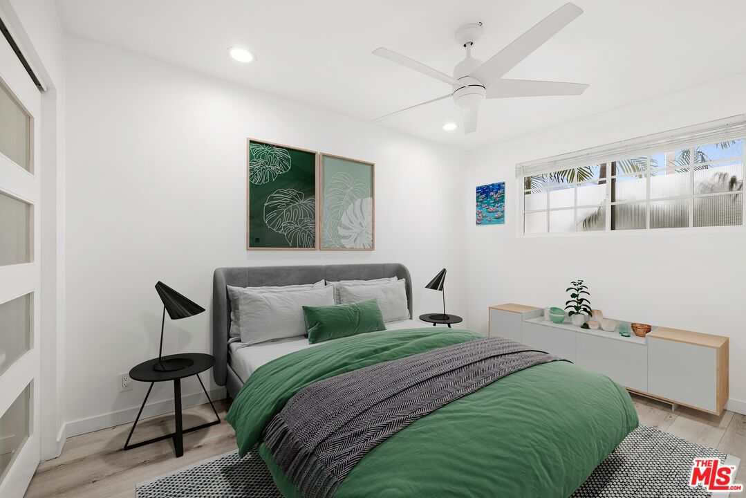 927 Euclid Street, Unit B Santa Monica, CA 90403 - Photo 5 of 8 a bedroom with a bed and a chandelier