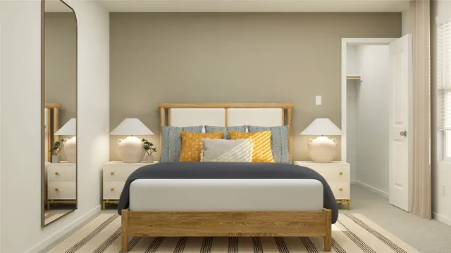 a large bed sitting in a bedroom next to a lamp