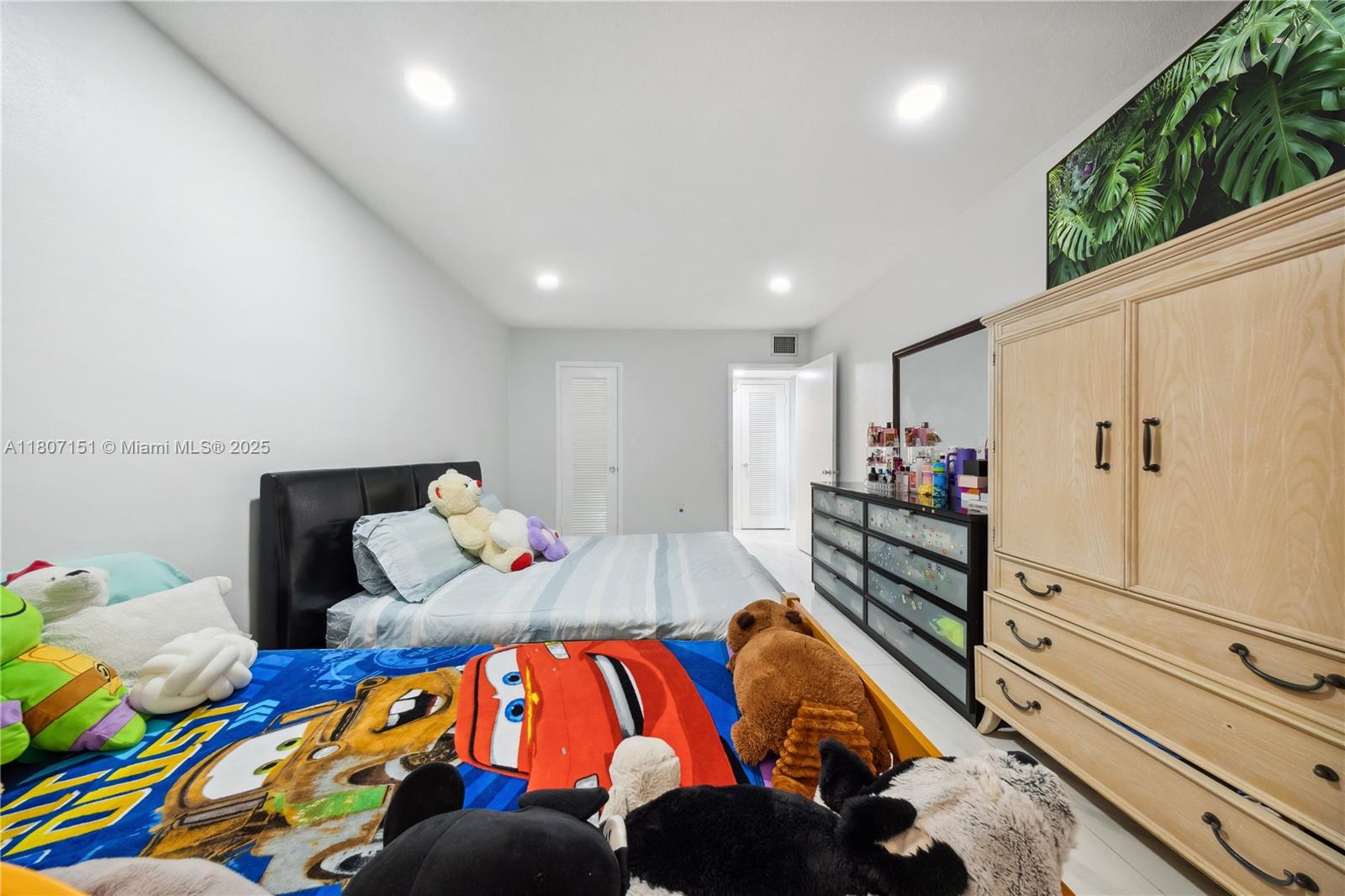 140 Royal Palm Road, Unit 3144 Hialeah Gardens, FL 33016 - Photo 11 of 23 a bedroom with a bed and wooden floor