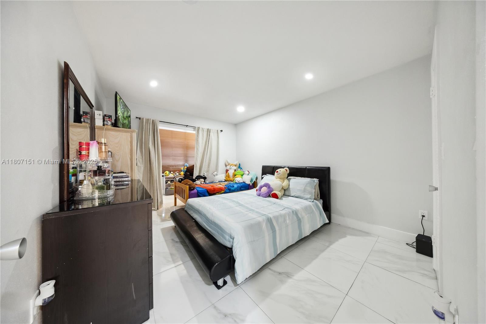 140 Royal Palm Road, Unit 3144 Hialeah Gardens, FL 33016 - Photo 13 of 23 a bedroom with a bed and a flat screen tv