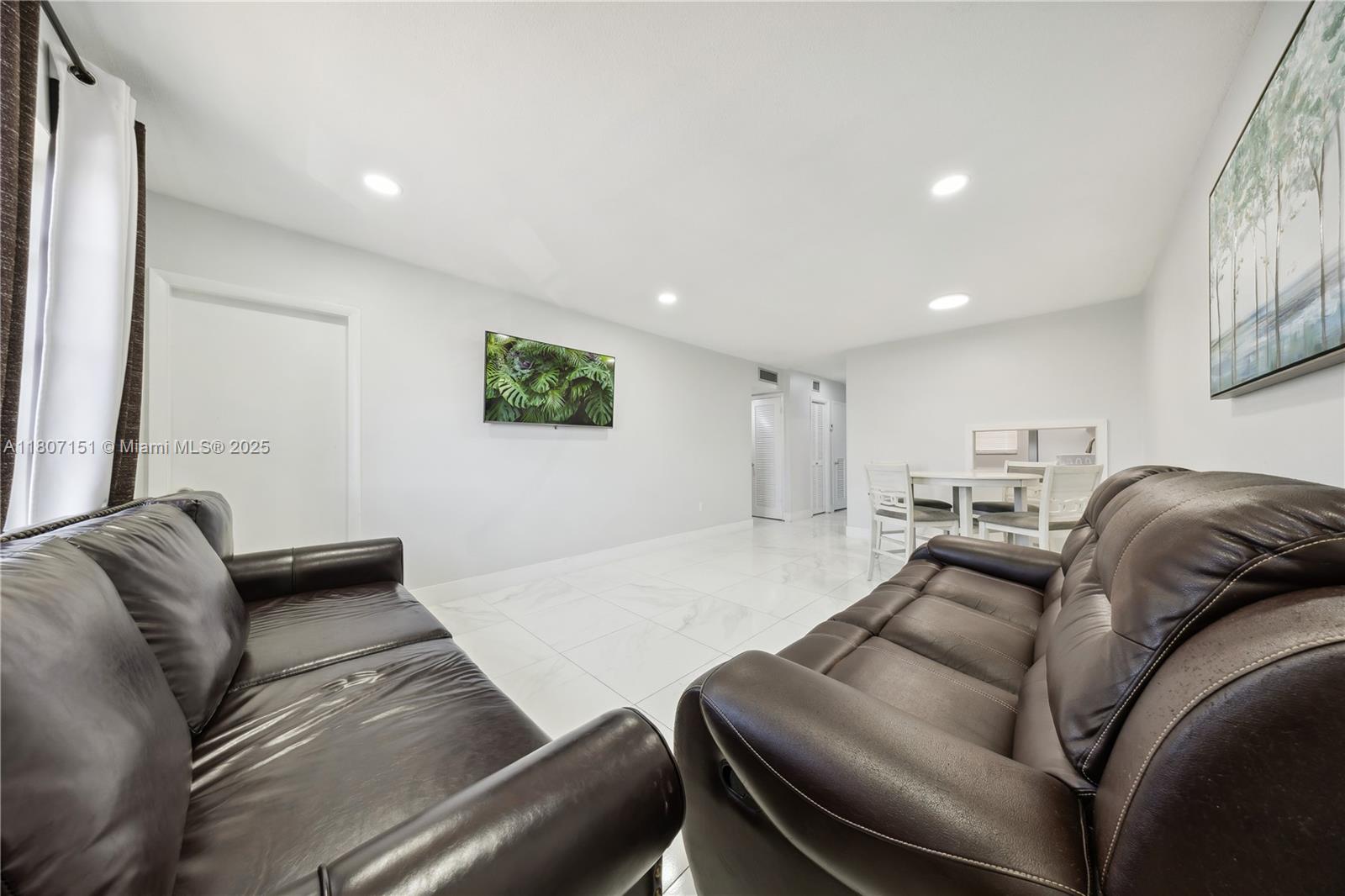 140 Royal Palm Road, Unit 3144 Hialeah Gardens, FL 33016 - Photo 19 of 23 a living room with furniture and a couch