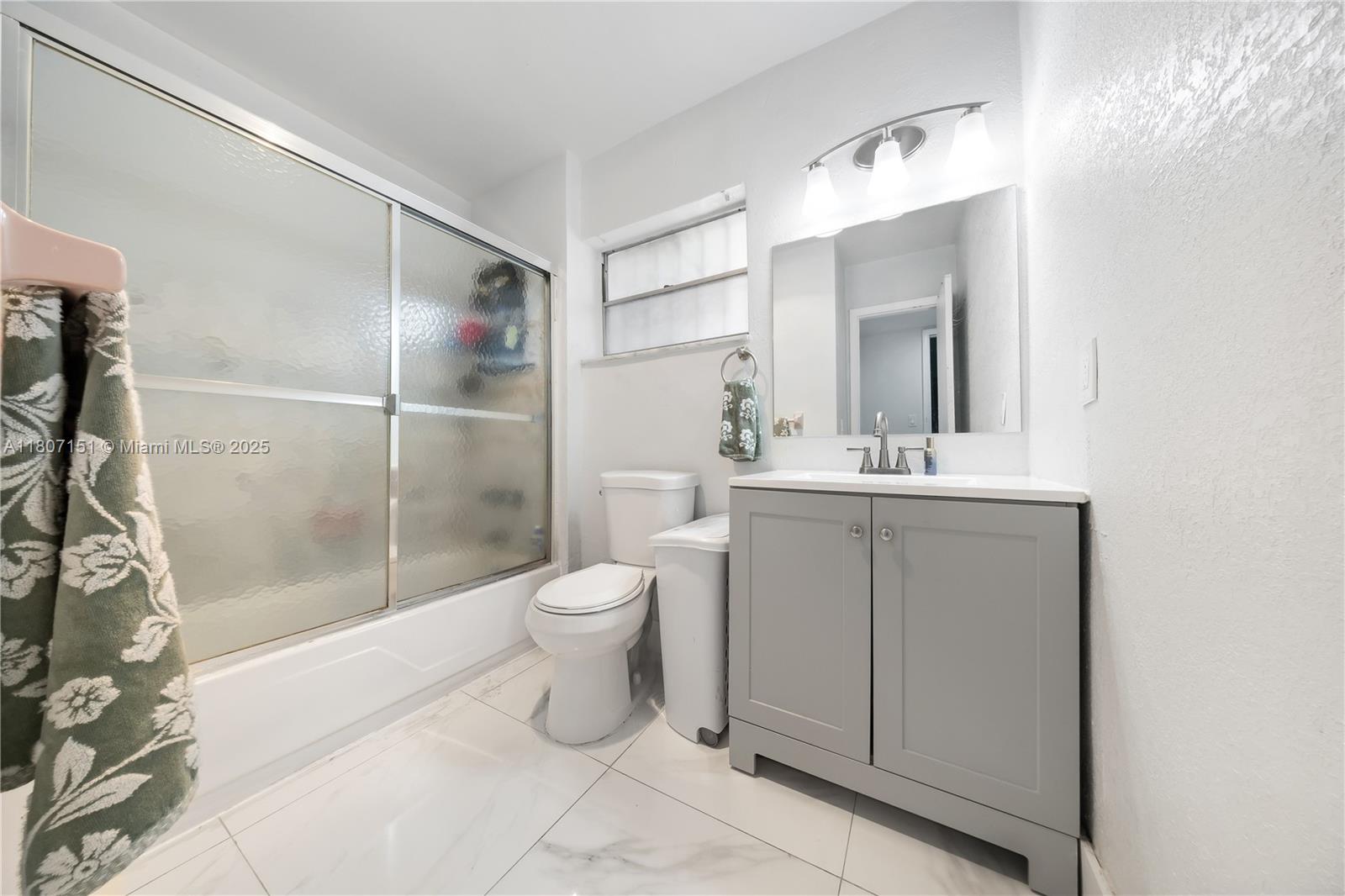 140 Royal Palm Road, Unit 3144 Hialeah Gardens, FL 33016 - Photo 22 of 23 a bathroom with a toilet sink and shower