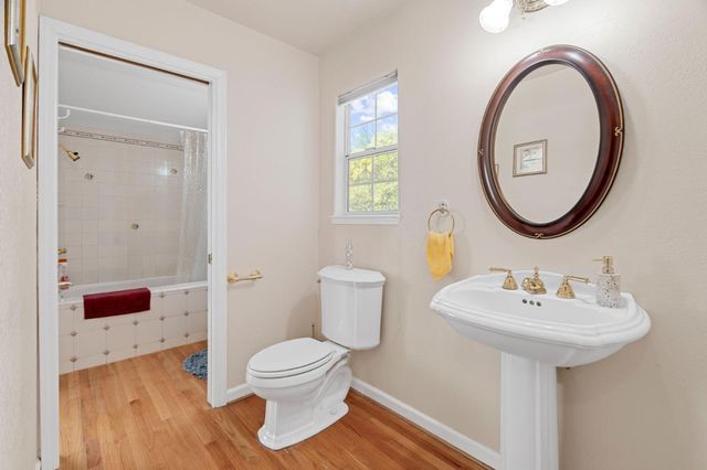 a bathroom with a sink toilet and a mirror