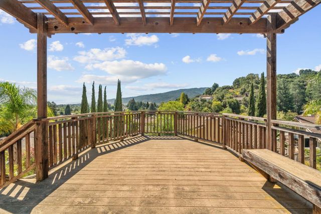 a view of a balcony with chairs and wooden floor