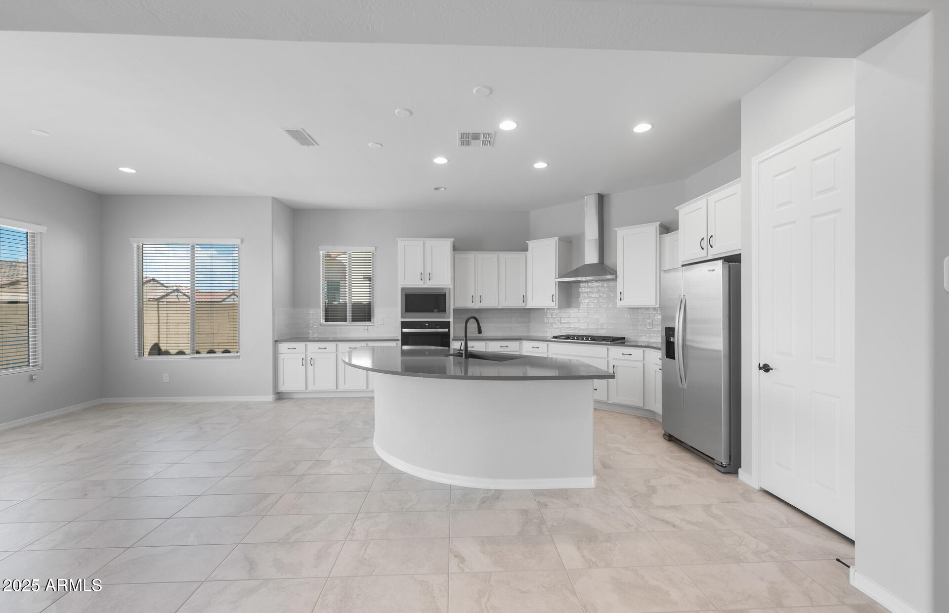 7906 West Mockingbird Way Florence, AZ 85132 - Photo 10 of 36 a kitchen with stainless steel appliances a refrigerator sink and cabinets