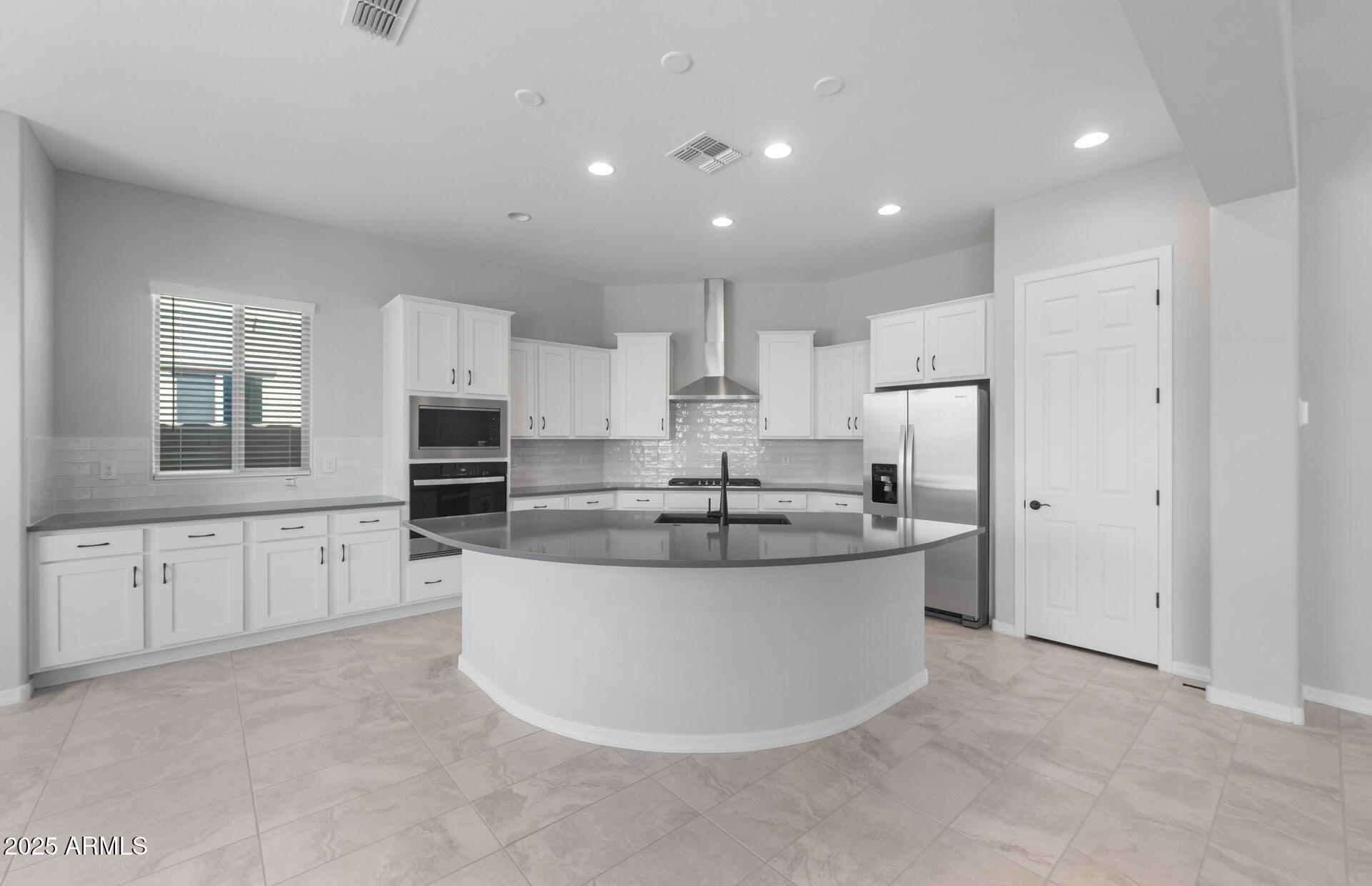 7906 West Mockingbird Way Florence, AZ 85132 - Photo 11 of 36 a white kitchen with stainless steel appliances granite countertop a sink and a refrigerator