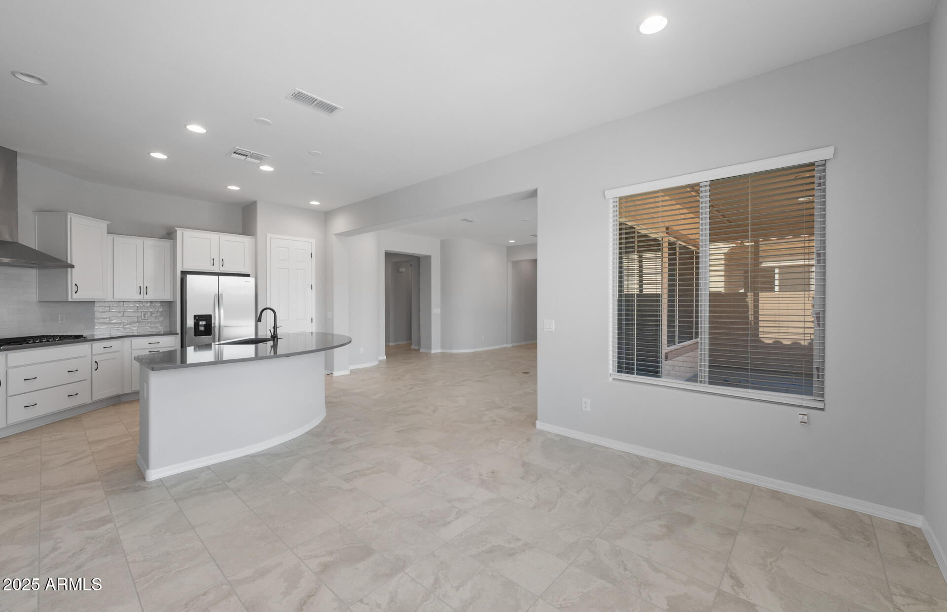 7906 West Mockingbird Way Florence, AZ 85132 - Photo 17 of 36 a large white kitchen with kitchen island a sink appliances and a cabinets
