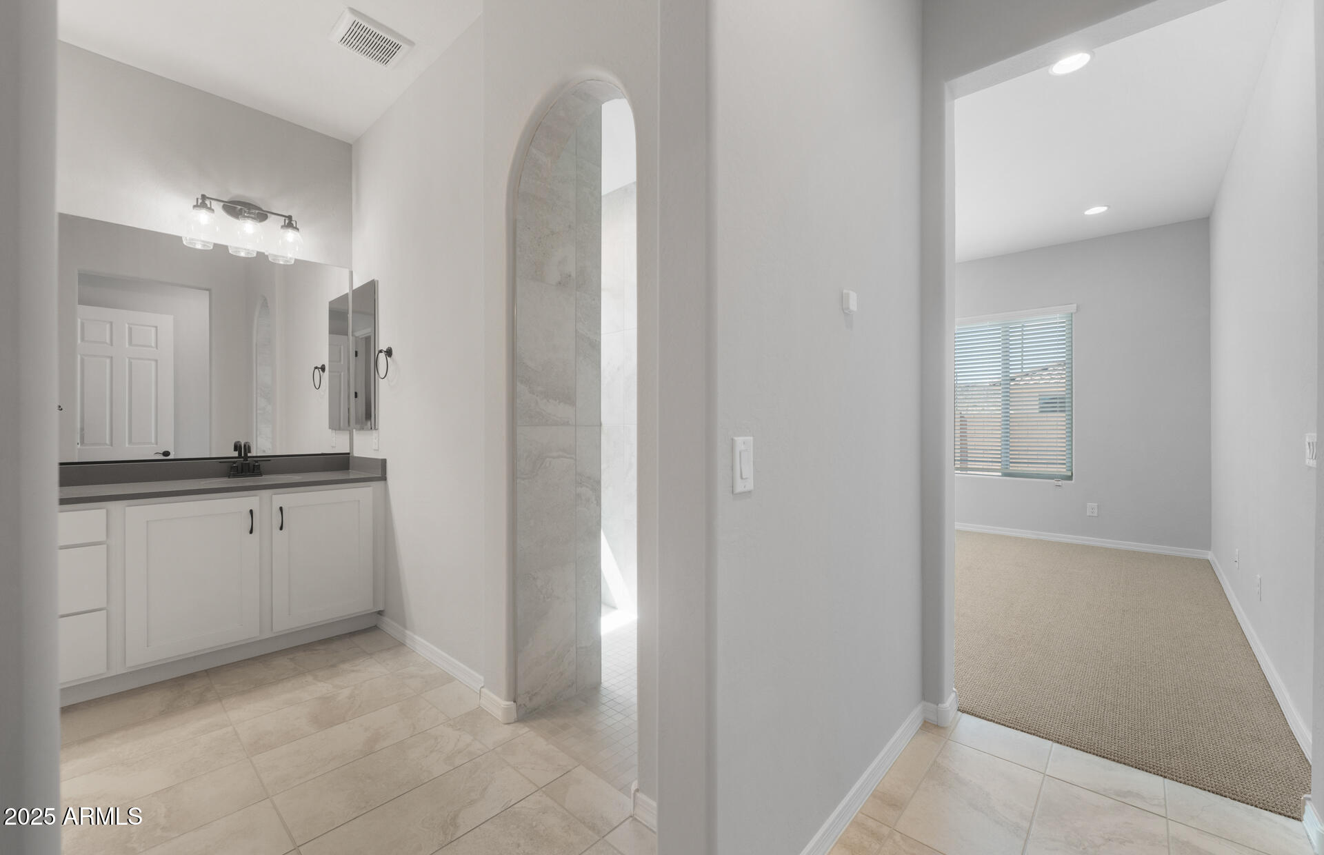 7906 West Mockingbird Way Florence, AZ 85132 - Photo 18 of 36 a bathroom with a double vanity sink and mirror