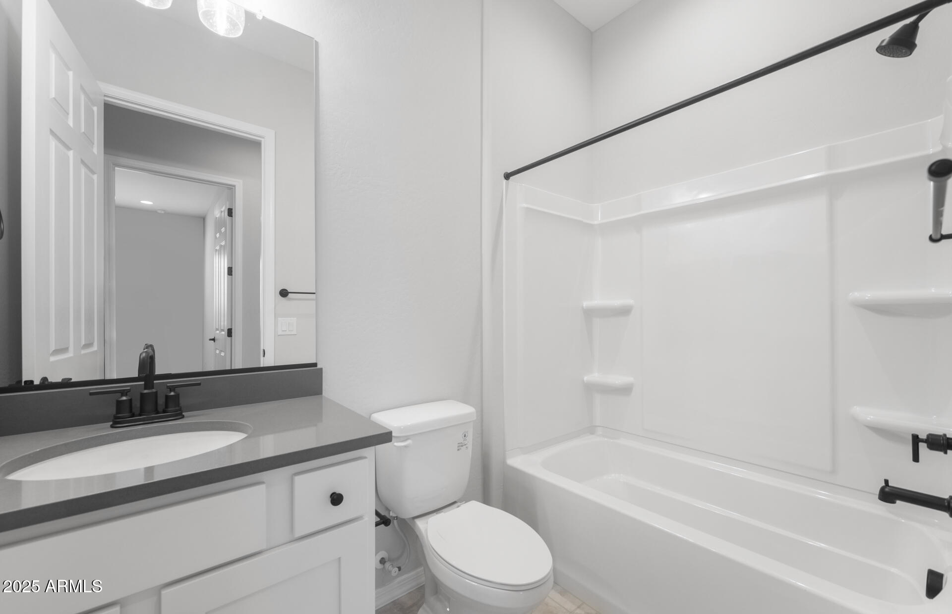 7906 West Mockingbird Way Florence, AZ 85132 - Photo 4 of 36 a bathroom with a granite countertop sink a toilet and a bathtub