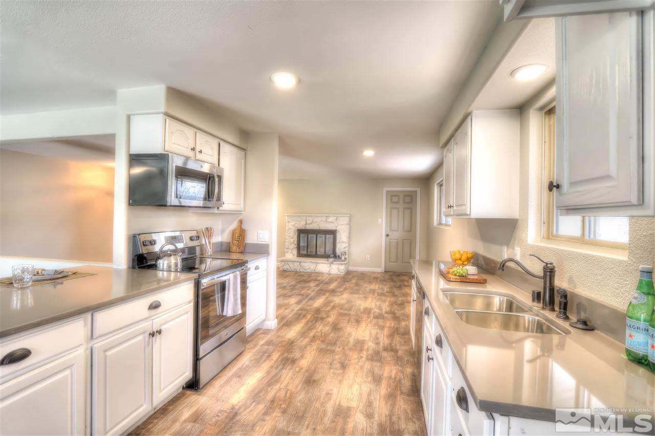 4130 Edrie Drive Reno, NV 89502 - Photo 1 of 1 a large kitchen with granite countertop a sink and a stove top oven