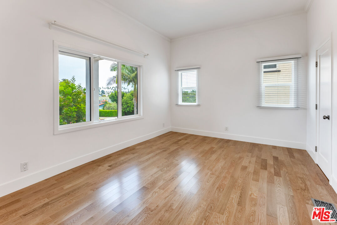1253 South Rimpau Boulevard Los Angeles, CA 90019 - Photo 61 of 71 a view of an empty room with wooden floor and a window