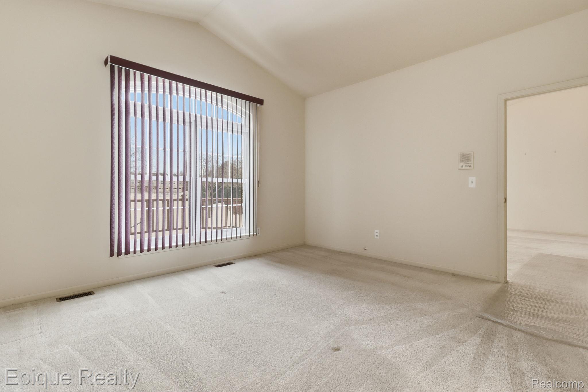321 Cherry Grove Road Canton, MI 48188 - Photo 13 of 22 Spare room featuring light carpet and lofted ceiling