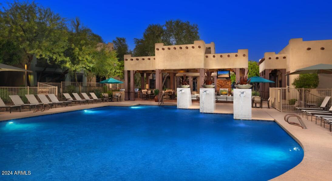a view of a swimming pool with outdoor seating