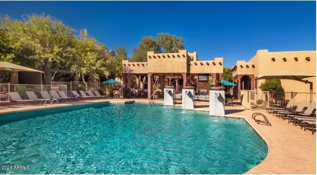 a view of a swimming pool with outdoor seating