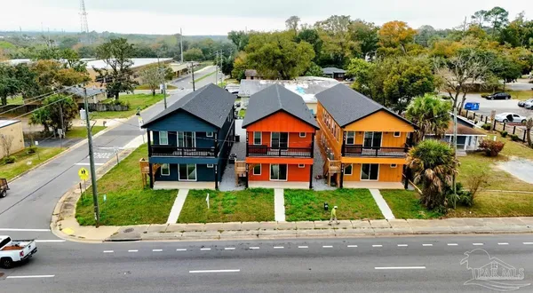 a front view of residential houses with yard and green space