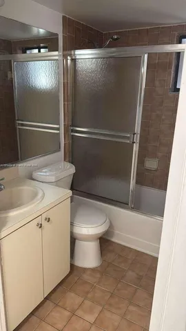 a bathroom with a shower and a toilet