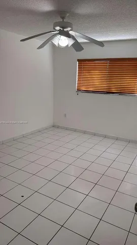 a view of a room with a projector and fan