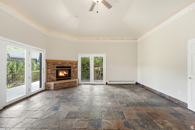 3535 Homestead Road Park City, UT 84098 - Photo 30 of 81 Spacious interior featuring natural stone tile flooring, a brick fireplace with a wood mantle, and multiple sets of glass French doors opening to outdoor spaces