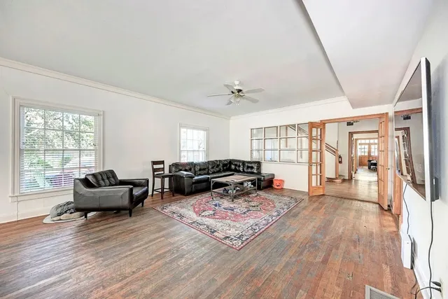 a living room with furniture and wooden floor