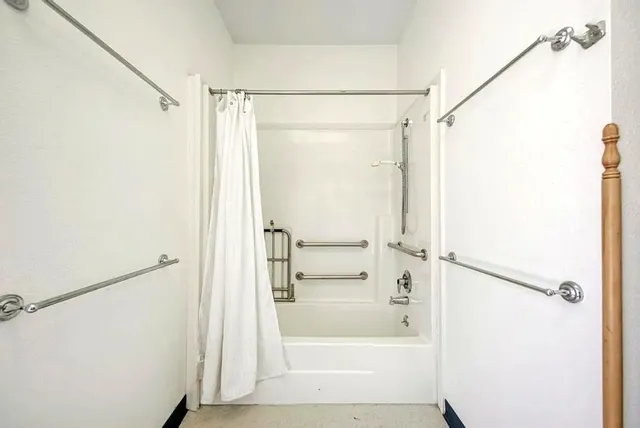 a bathroom with a glass shower door