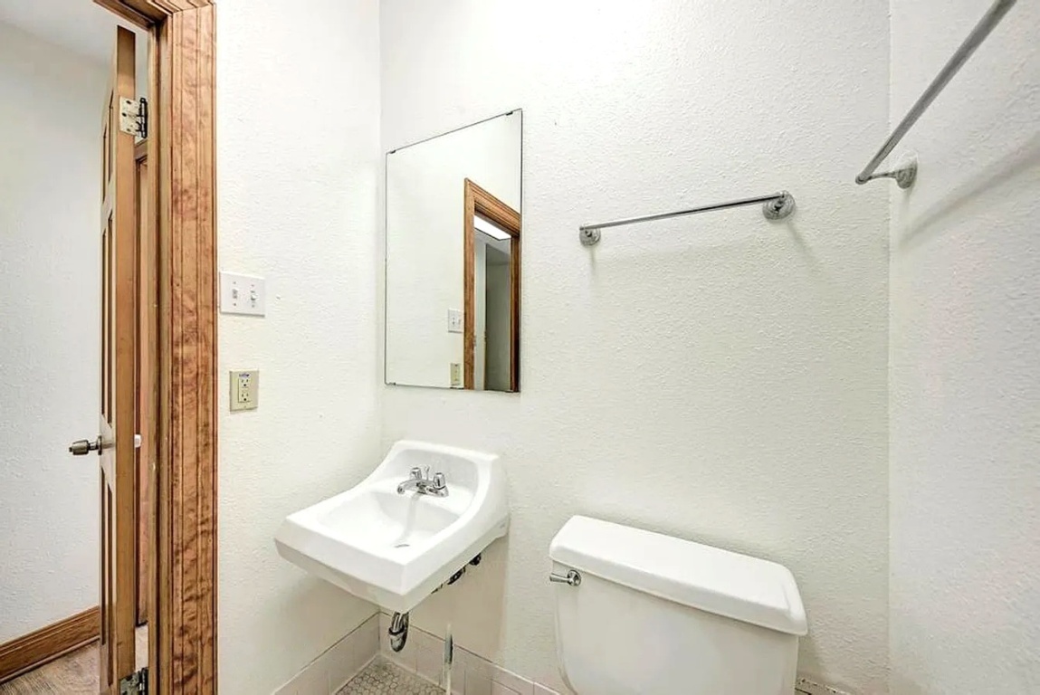 1919 Robbins Place Austin, TX 78705 - Photo 19 of 28 a bathroom with a toilet a sink and a mirror